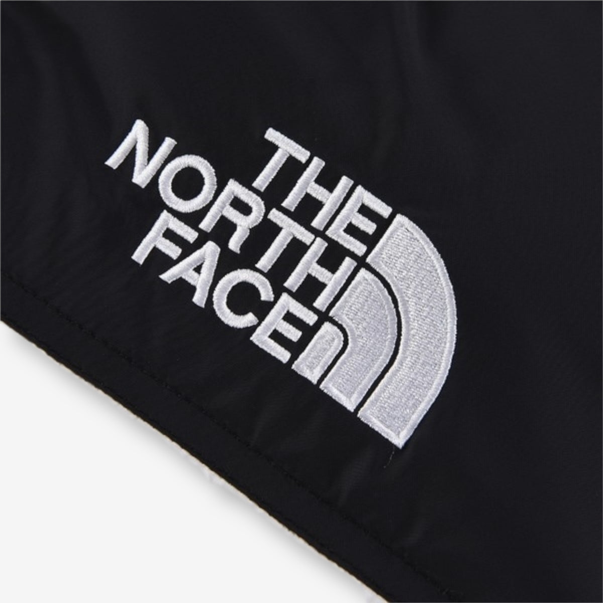 The North Face 1996 Retro Nuptse Jacket – White with black upper panel.