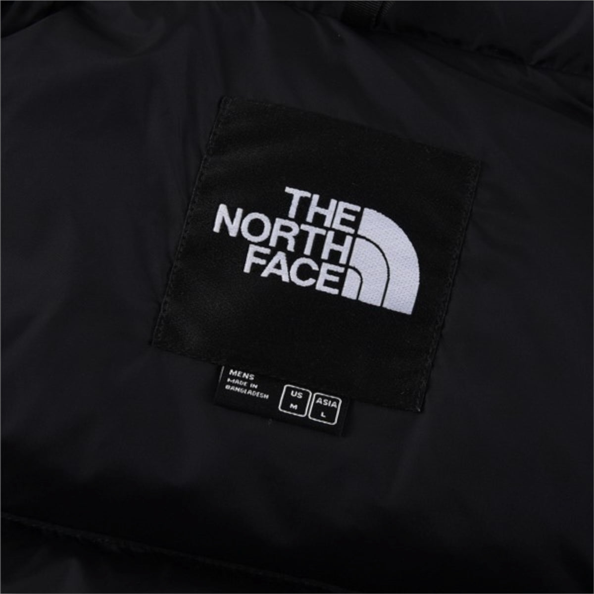 The North Face 1996 Retro Nuptse Jacket – White with black upper panel.